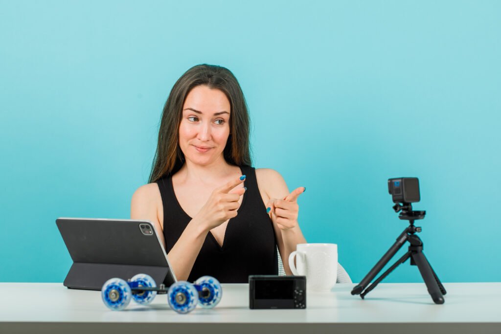 Woman recording a product review using a camera and tablet for a video review app for businesses.