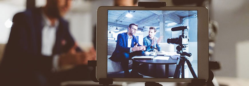 Business professionals recording a testimonial using a customer video reviews tool for brand marketing.