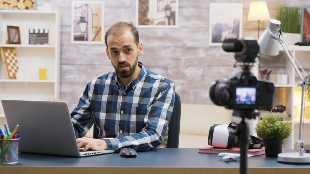 Man recording a video using a video review marketing platform for business growth.